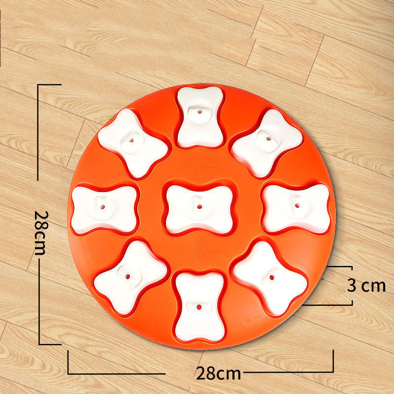 Orange round tray with white bone-shaped compartments on a wooden surface