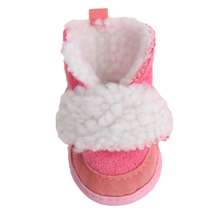Pink baby bootie with white fur lining on a white background