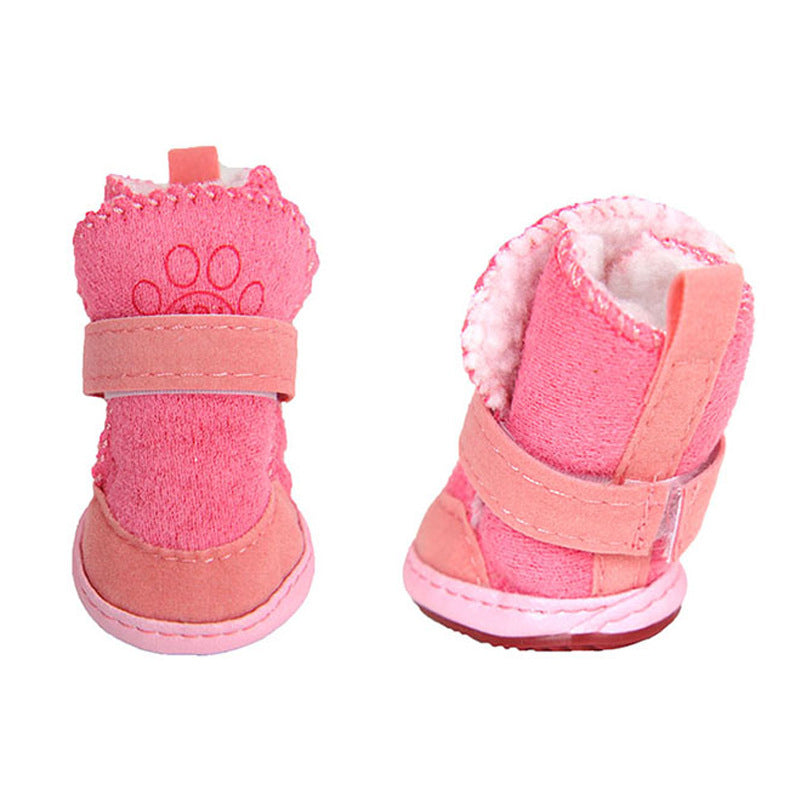 Pair of pink pet boots with paw design on a white background